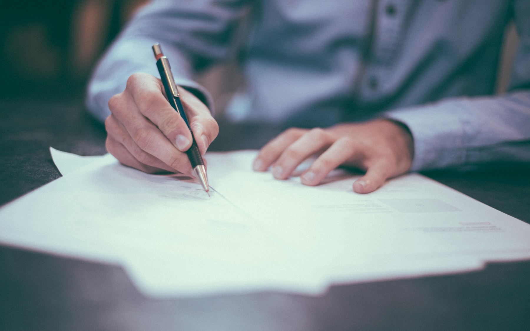 Professional signing a document to approve completed work