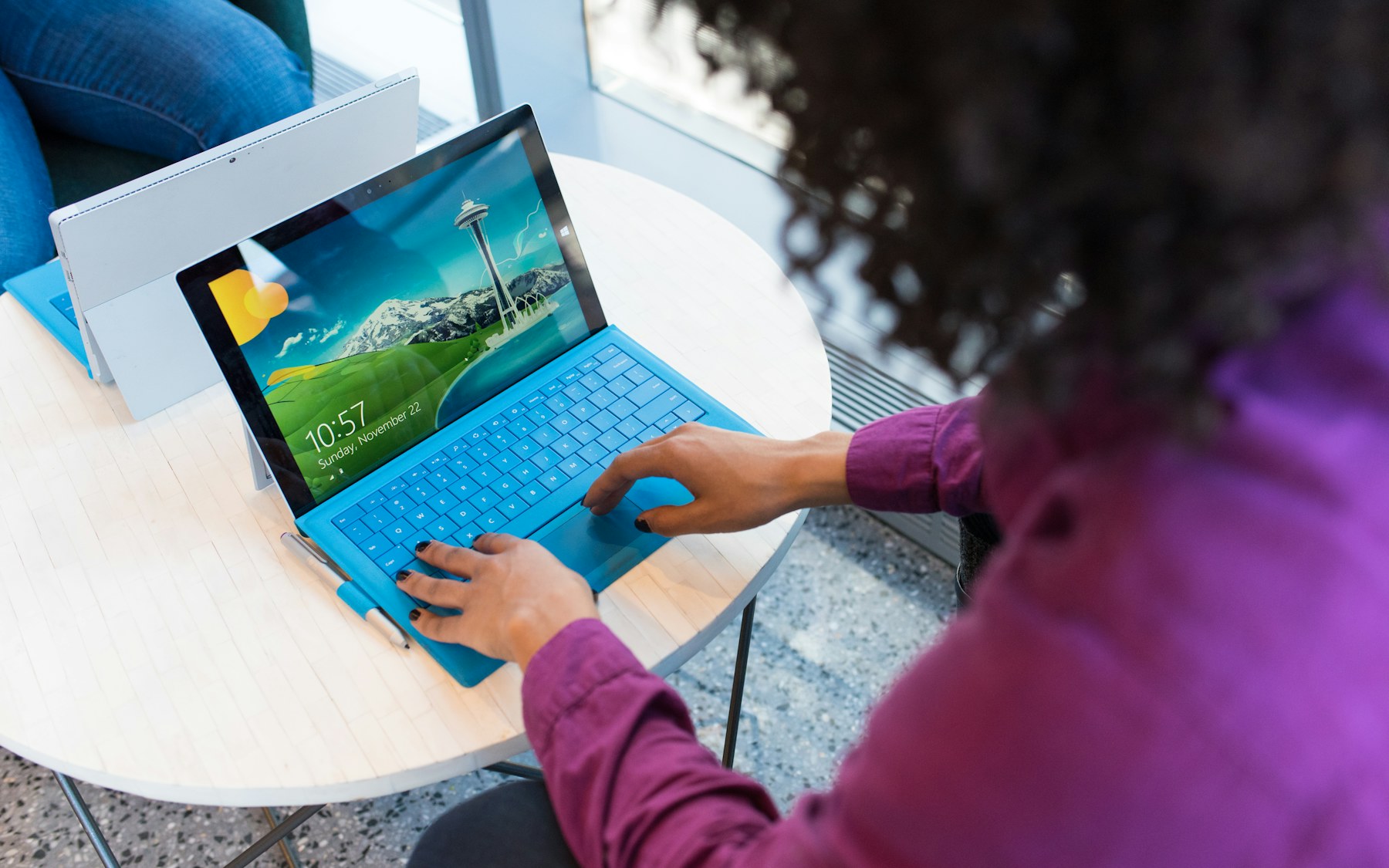 Professional working on a tablet laptop at a small table