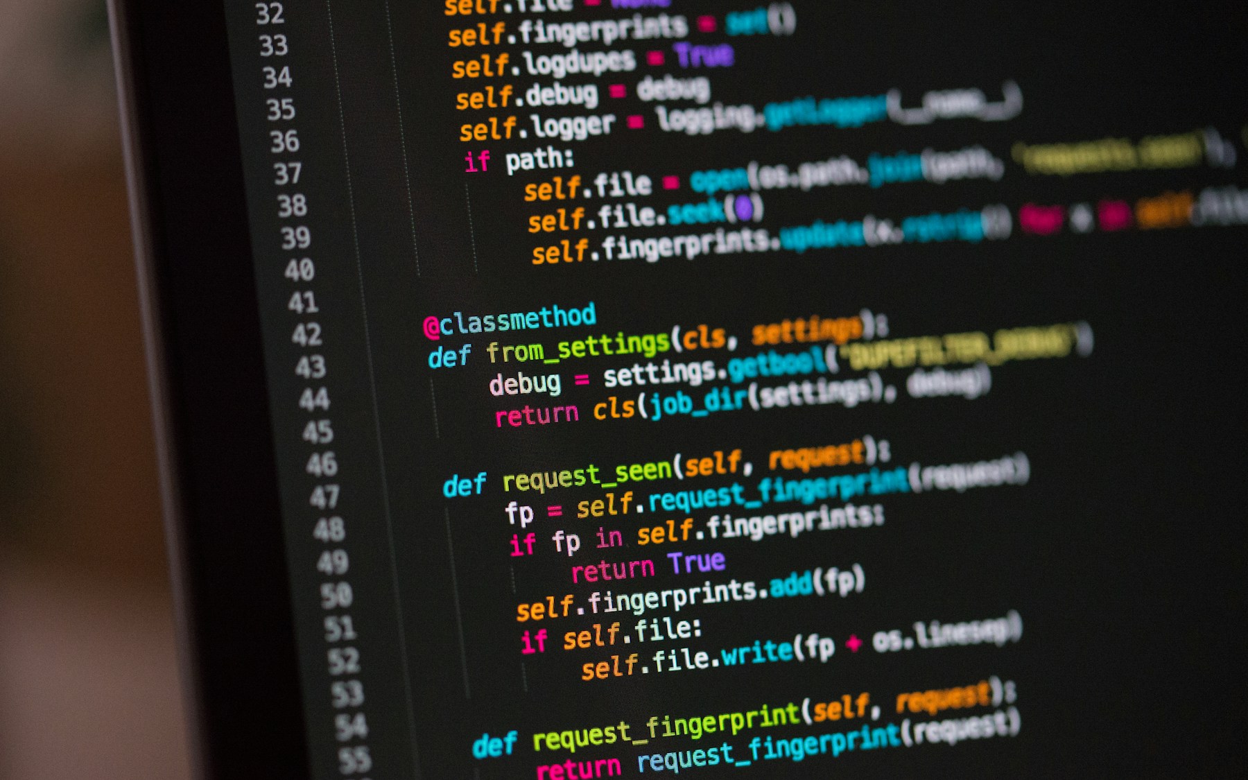 Experienced developer reviewing source code on a computer